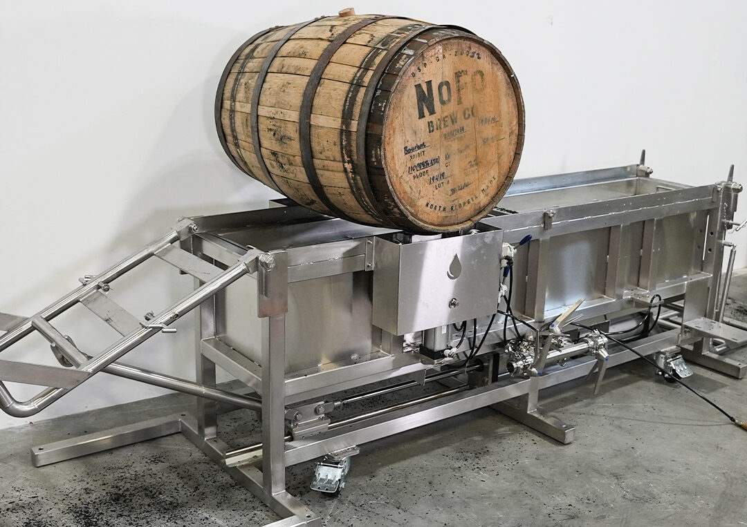 image of a barrel lift and emptying skid being used in a beverage production facility