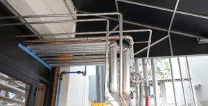 Photo of chemical feed line piping for a brewery and beverage producer.